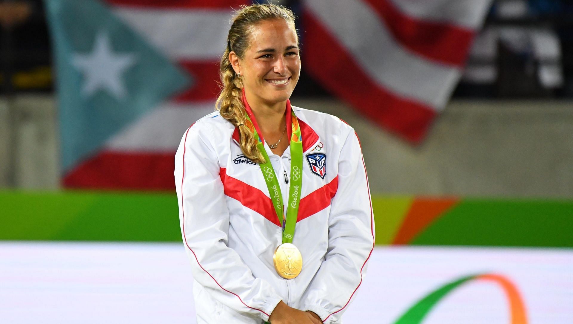 Monica Puig poses at the podium with her gold medal at the Rio Olympics