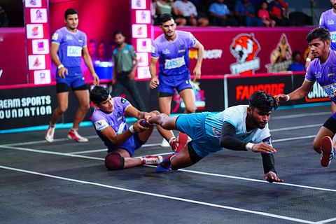 Tamil Thalaivas' K. Prapanjan, in blue and yellow jersey, is pinned down by  players of Patna Pirates during their Vivo Pro Kabaddi league match in  Mumbai, India, Saturday, Aug. 26, 2017. (AP