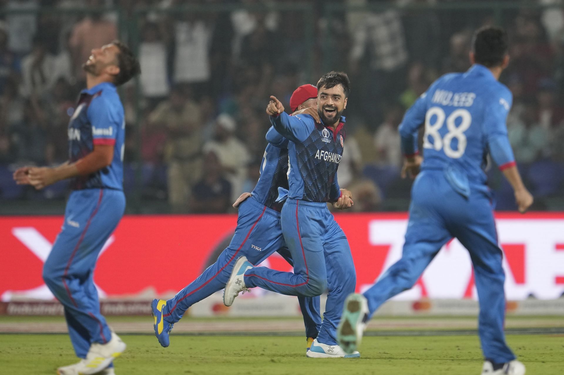 Rashid Khan celebrating with his teammates [Getty Images]