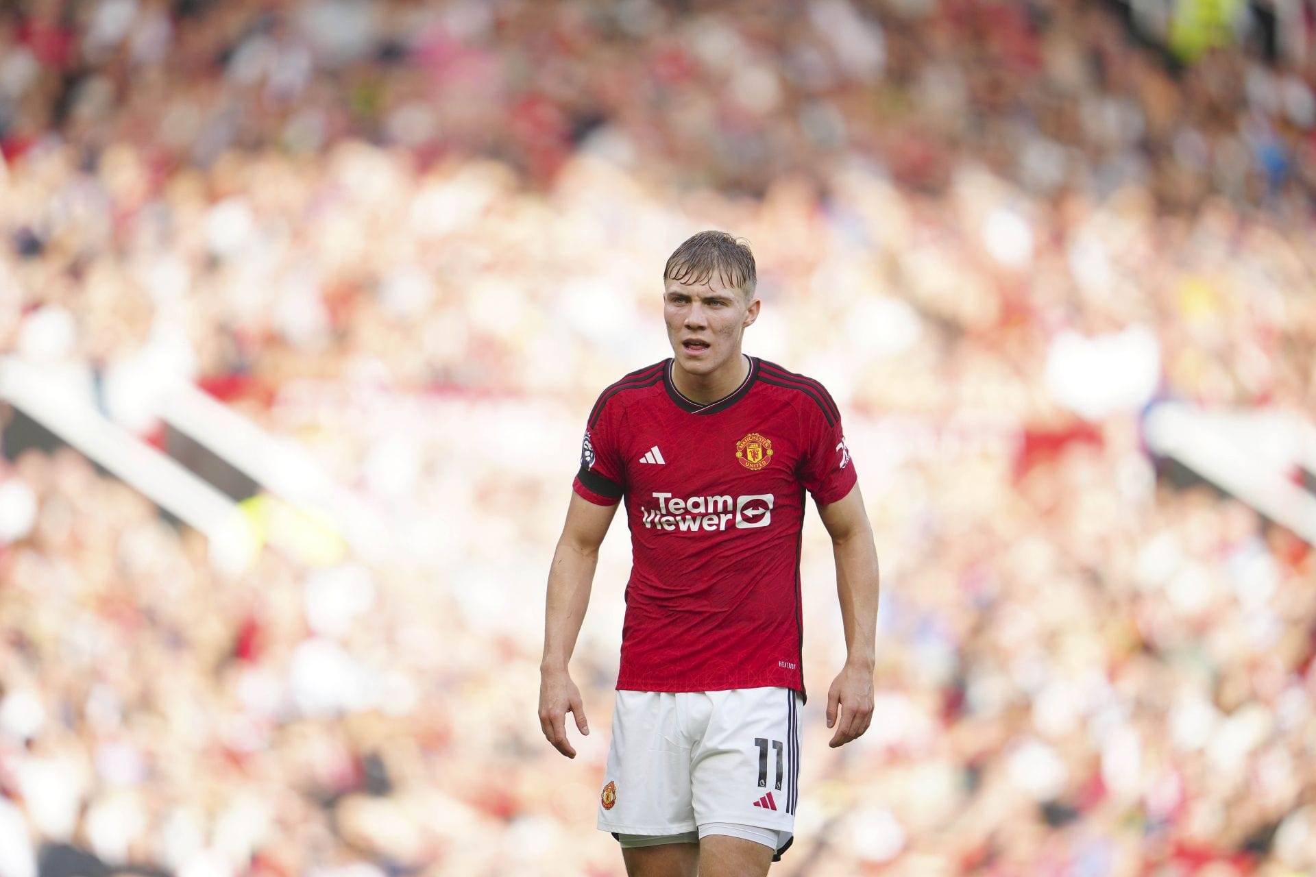 Rasmus Hojlund is working hard high up the park