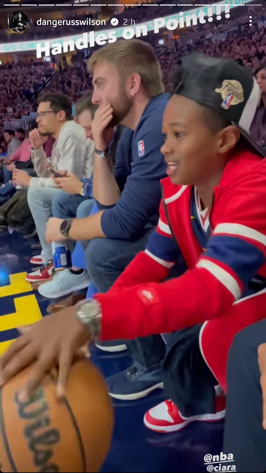 Russell and son at an NBA game