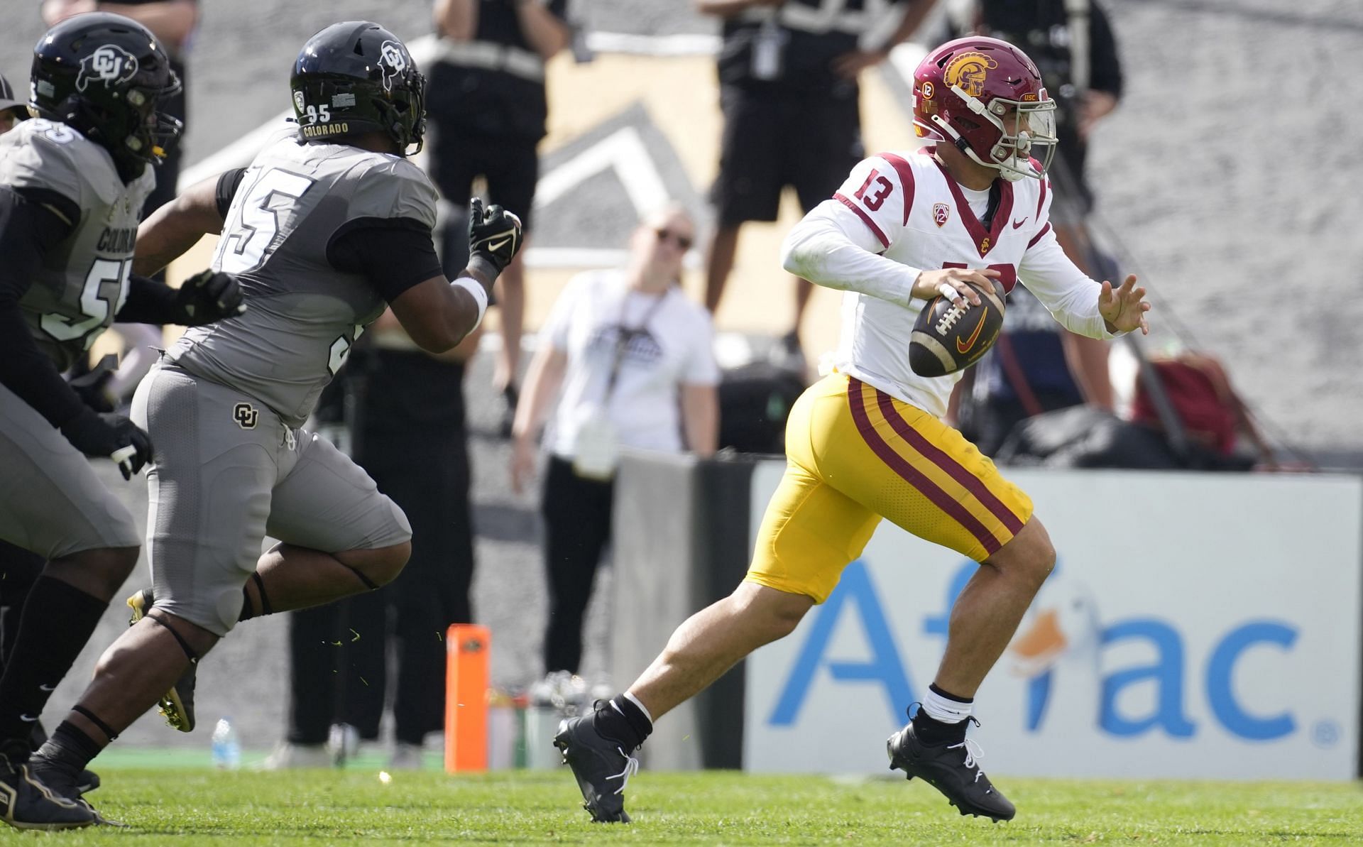 USC Colorado Football: Southern California quarterback Caleb Williams, right, looks to pass the ball as Colorado defensive lineman Bishop Thomas pursues in the first half of an NCAA college football game, Saturday, Sept. 30, 2023, in Boulder, Colo. (AP Photo/David Zalubowski)