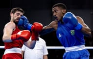 : Yunior Alcantara of Team Dominican Republic (red) and Roscoe Hill of Team United States (blue) in Boxing - Men's 51kg semifinal bout at Centro de Entrenamiento Olimpico at the 2023 Pan Am Games in Santiago, Chile.
