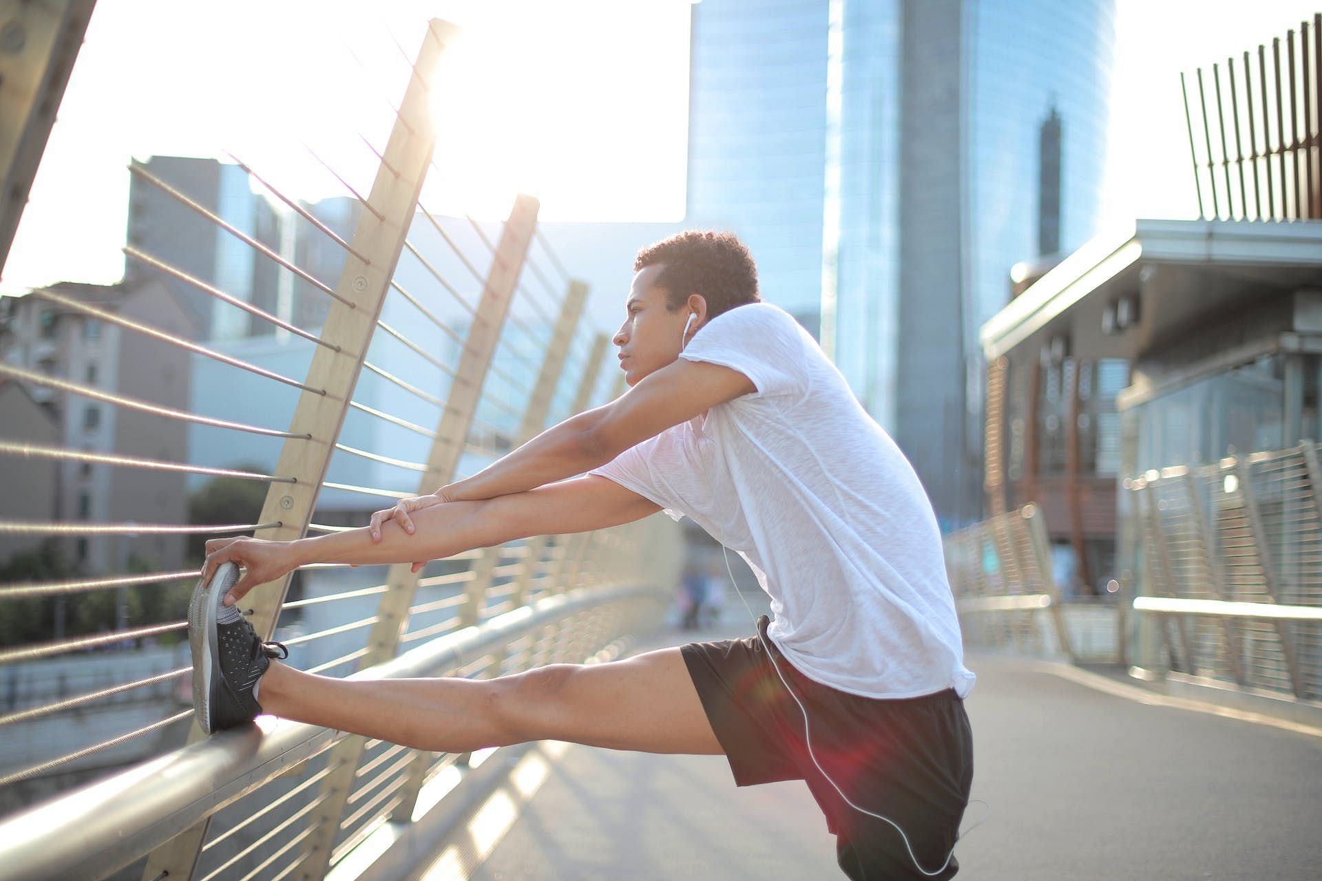 Leg stretches before workout boosts blood circulation. (Image via Pexels/Andrea Piacquadio)