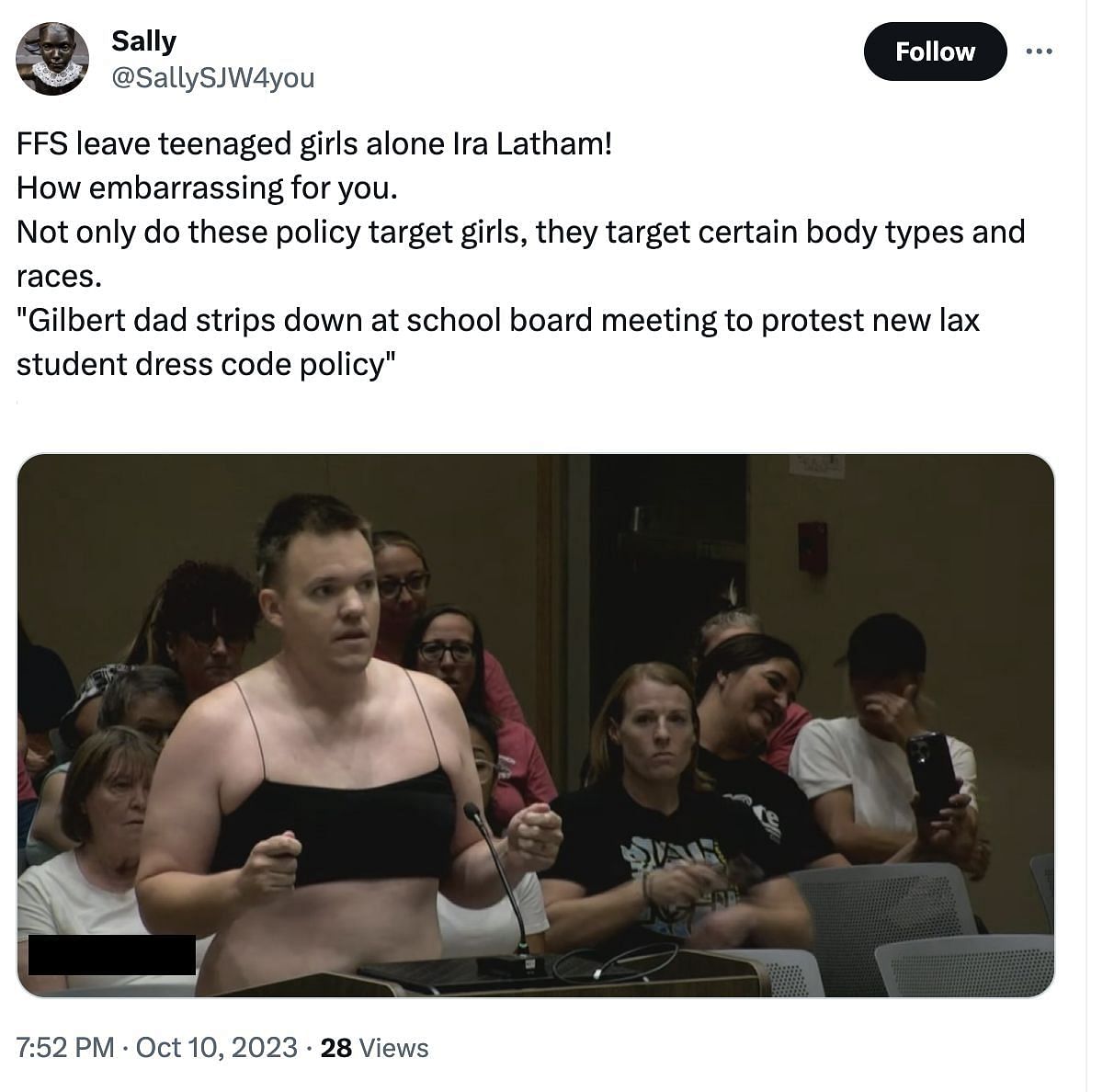 Latham, father of four, strips down at a school board meeting to protest about the new dress code policy. (Image via Twitter)