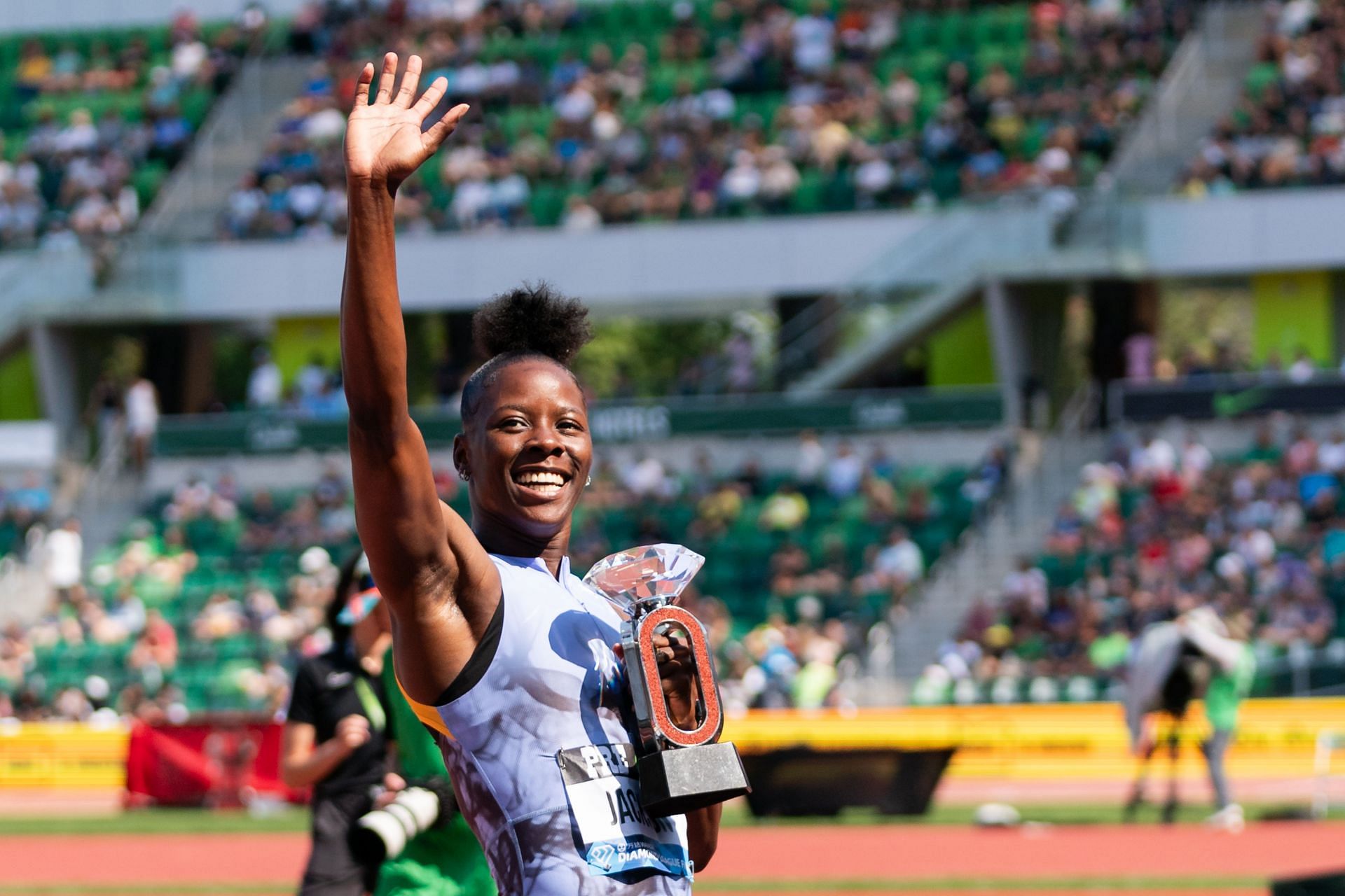 Shericka Jackson of Jamaica holds up the Diamond League Final trophy after winning the Women's 100m at Hayward Field in Eugene, Oregon