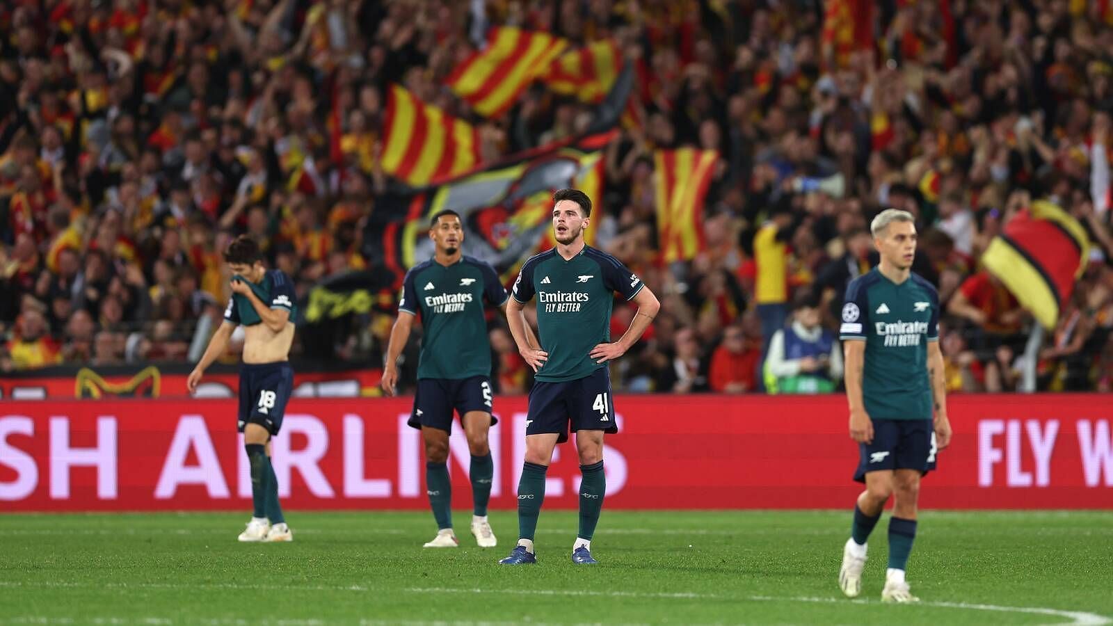 Arsenal players look dejected after losing 2-1 to RC Lens in the UCL.