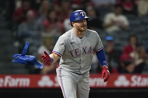 Robbie Grossman tosses his gloves after drawing a walk during a game against the Los Angeles Angels