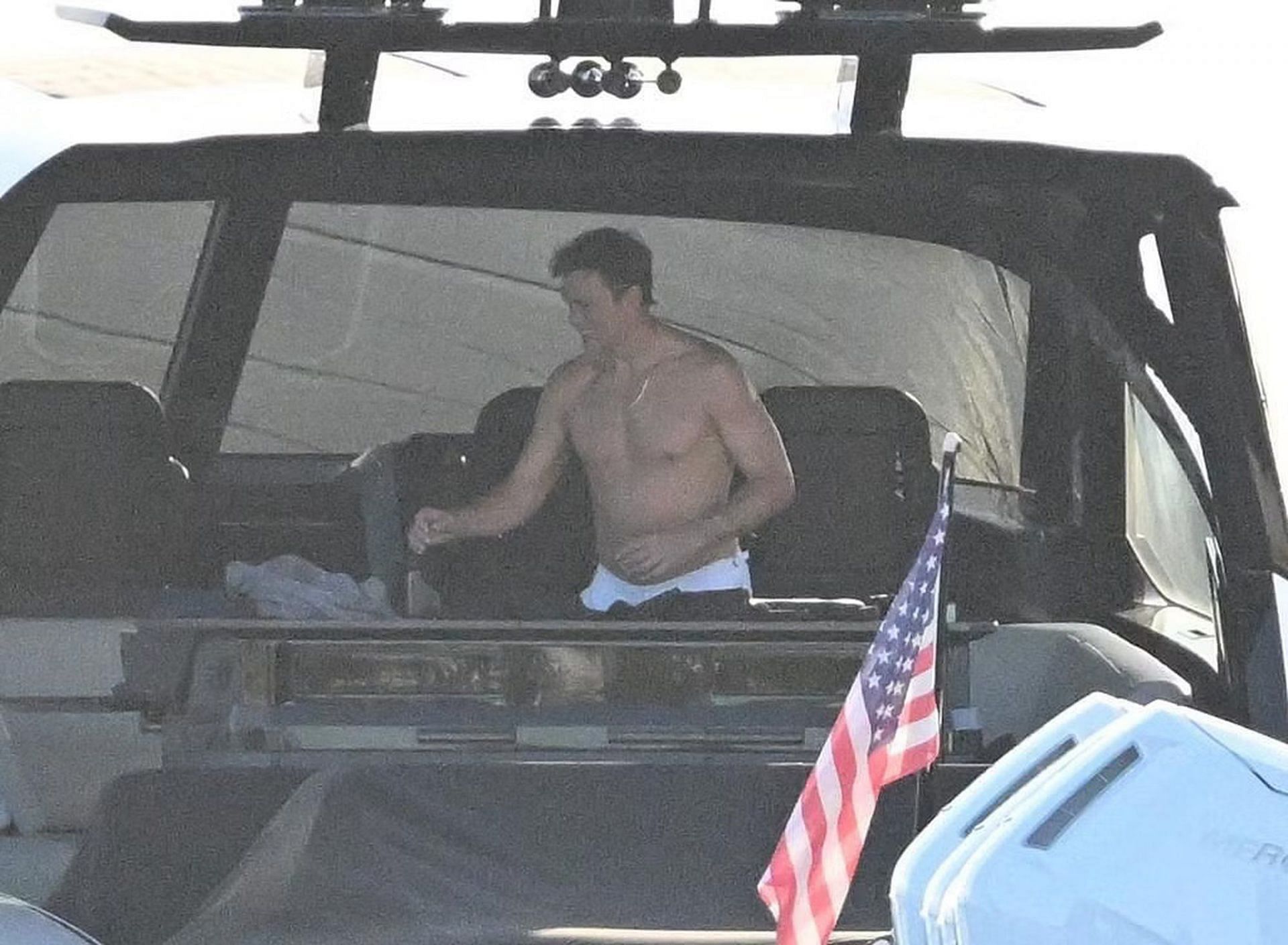 Tom Brady reaching for a towel inside his yacht (via Backgrid for Page Six)