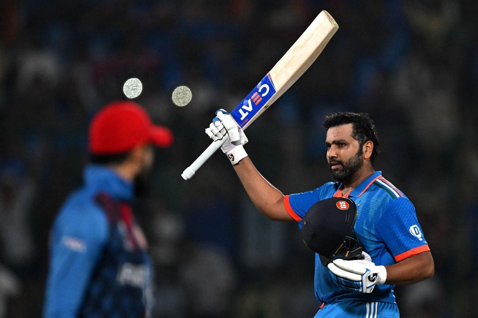 Rohit Sharma raising his bat after a century [Getty Images]
