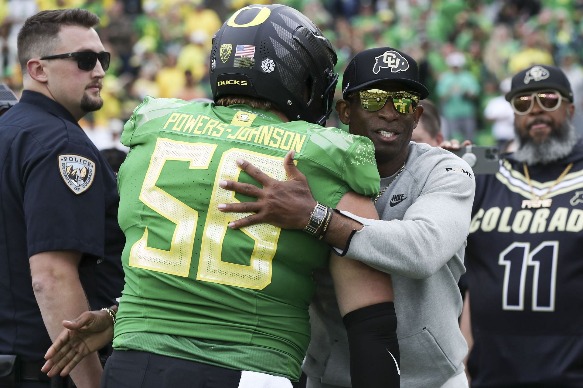 Colorado head coach Deion Sanders hugs Oregon offensive lineman Jackson Powers-Johnson (AP Photo/Amanda Loman)