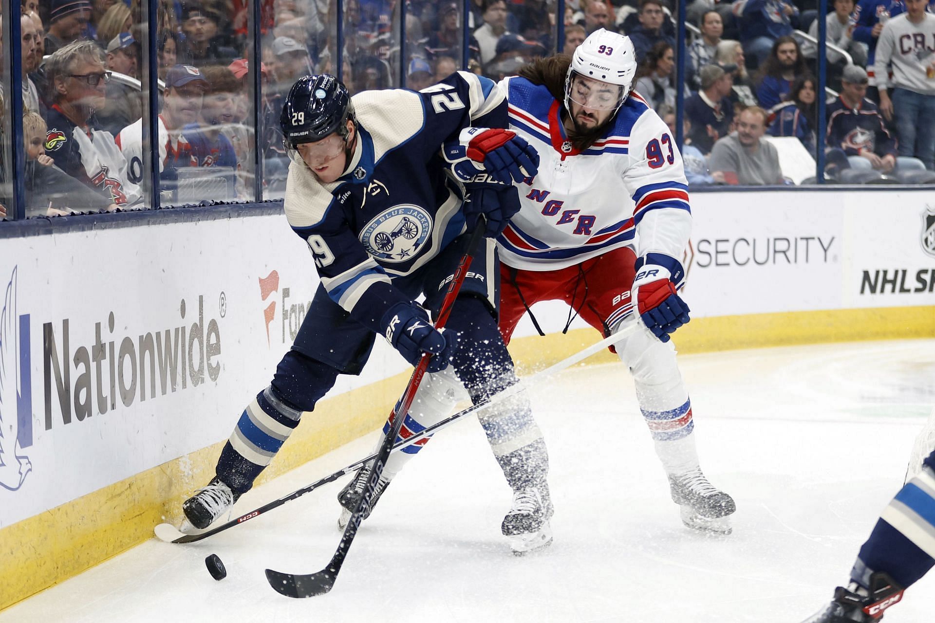 Columbus Blue Jackets forward Patrik Laine, left, chases the puck in front of New York Rangers forward Mika Zibanejad during the first period of an NHL hockey game in Columbus, Ohio, Oct. 14, 2023. (AP Photo/Paul Vernon)