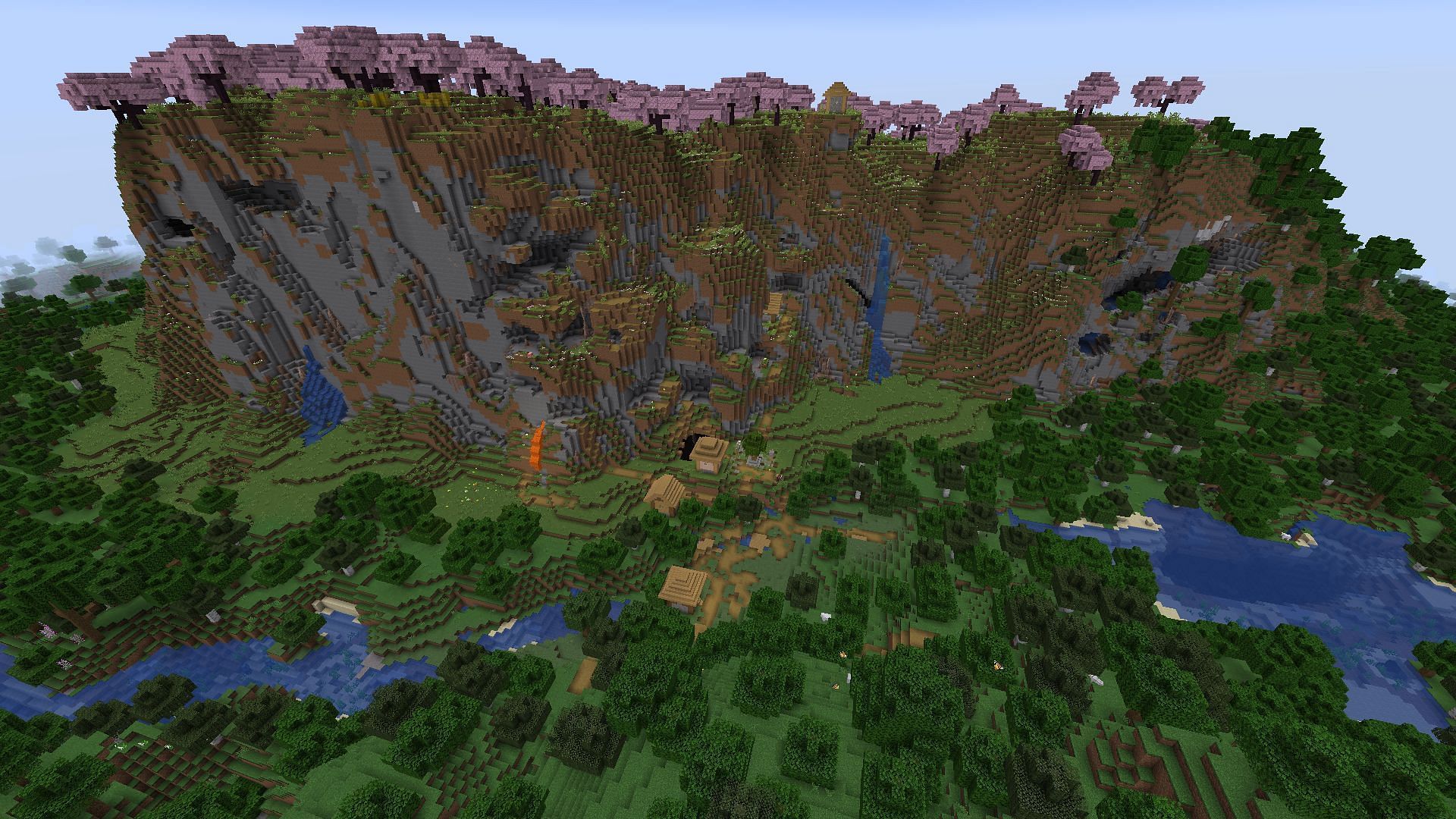 A cherry blossom grove rests overhead of two villages in this seed&#039;s spawn (Image via Mojang)