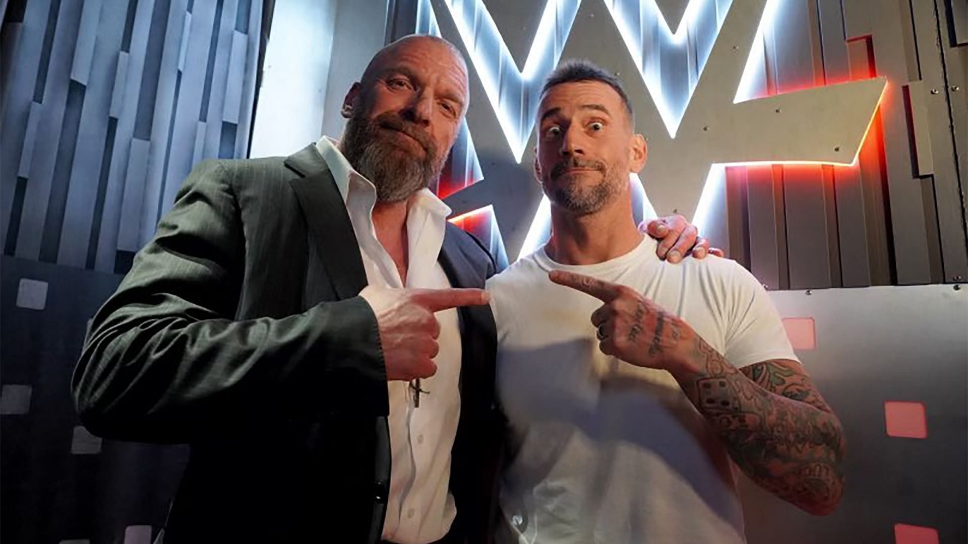 Triple H and CM Punk pose backstage at WWE Survivor Series