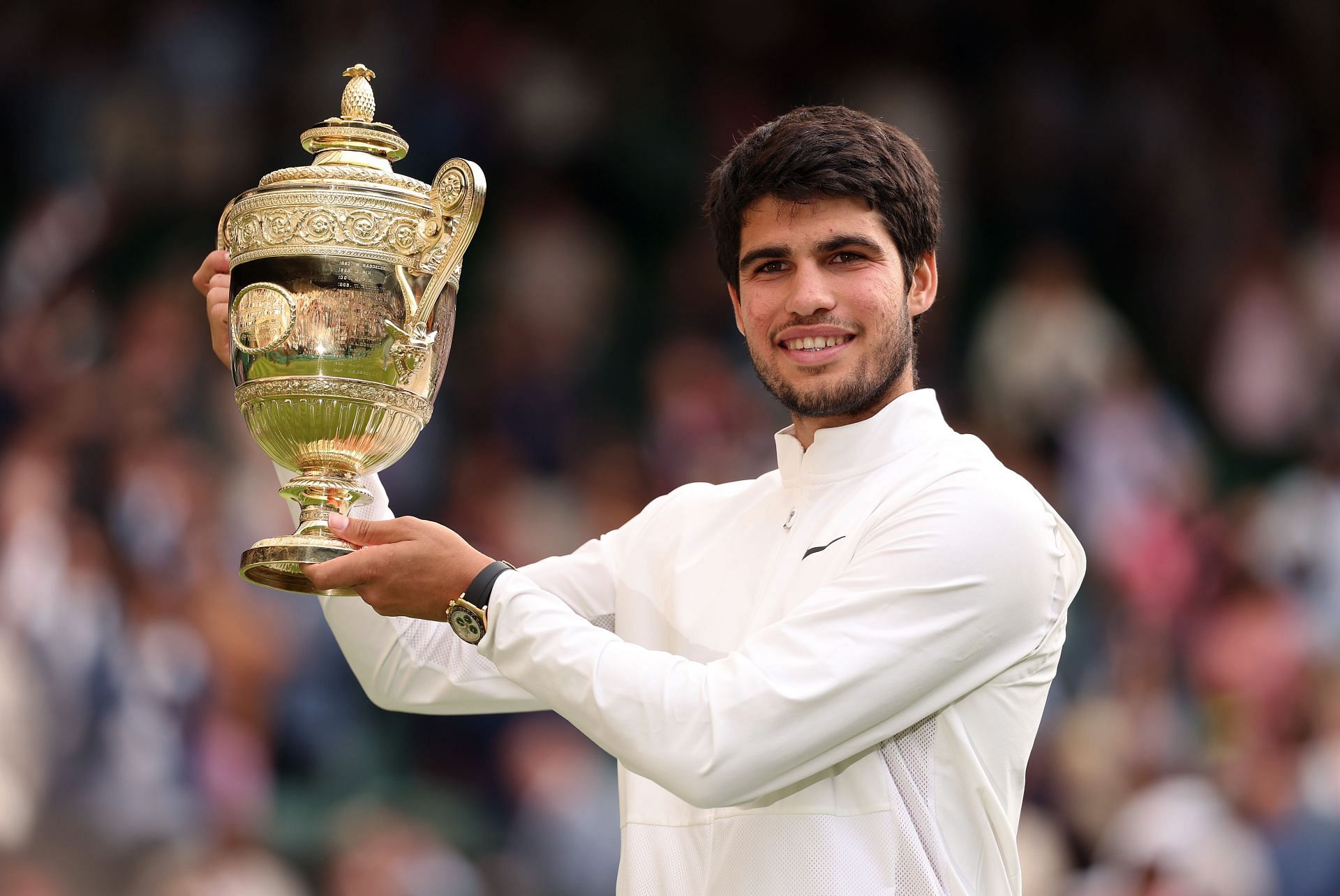 Carlos Alcaraz holds the Men&#039;s Singles Trophy at Wimbledon 2023