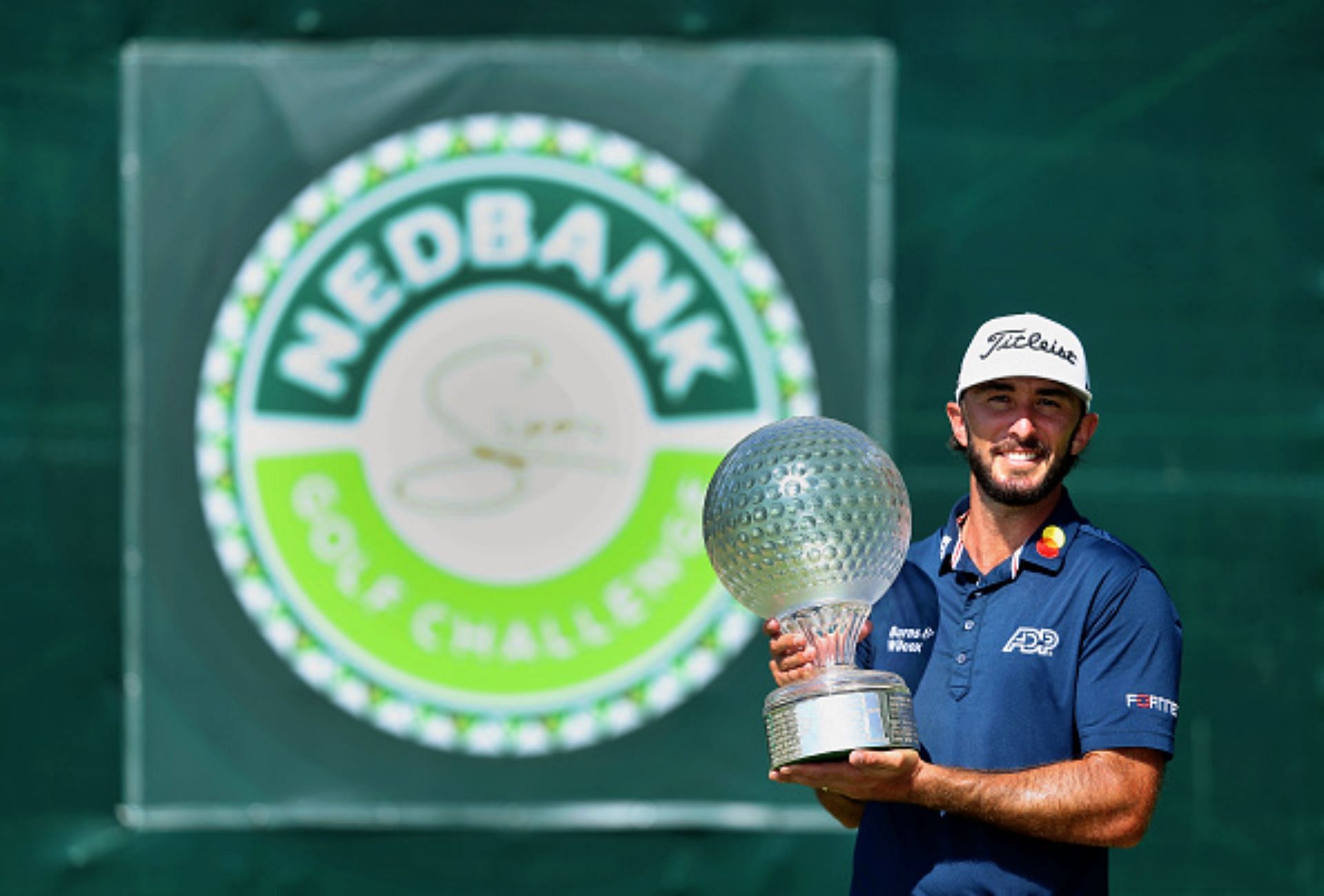 Max Homa holding the 2023 Nedbank Golf Challenge trophy (Image via Getty).