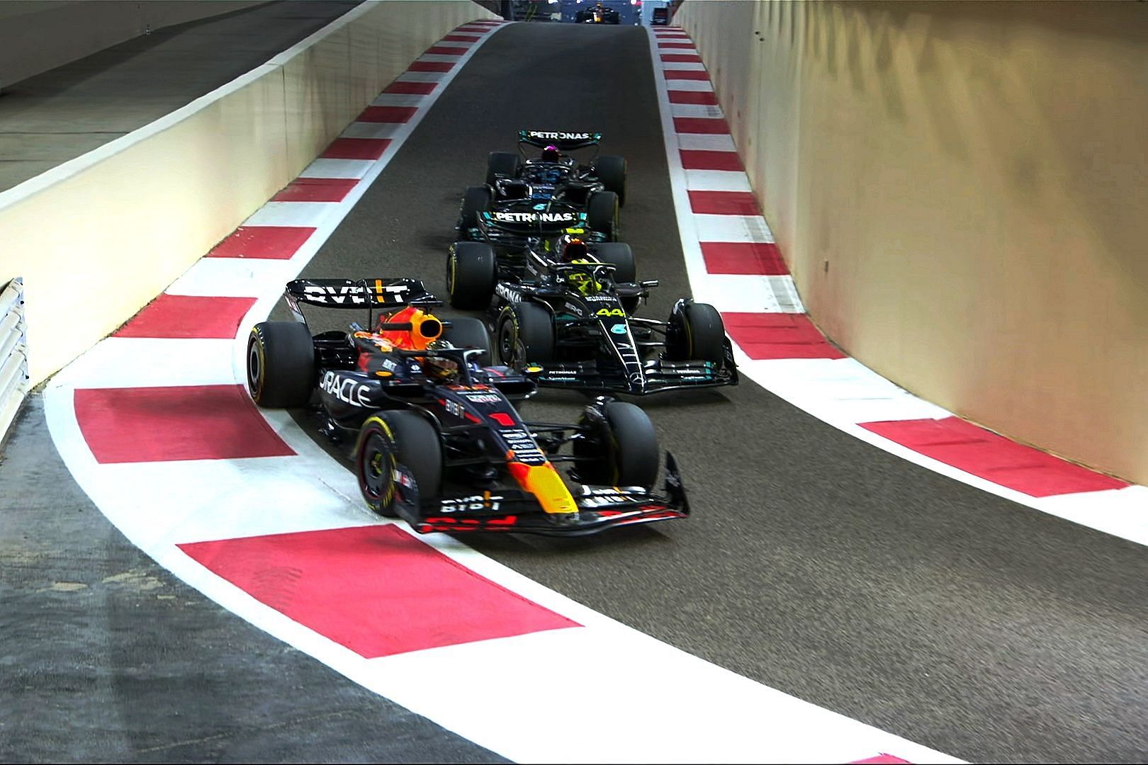 Max Verstappen (1) overtaking Lewis Hamilton (44) and George Russell (63) on the pit exit road during practice at the 2023 F1 Abu Dhabi Grand Prix (Image via X/@F1)