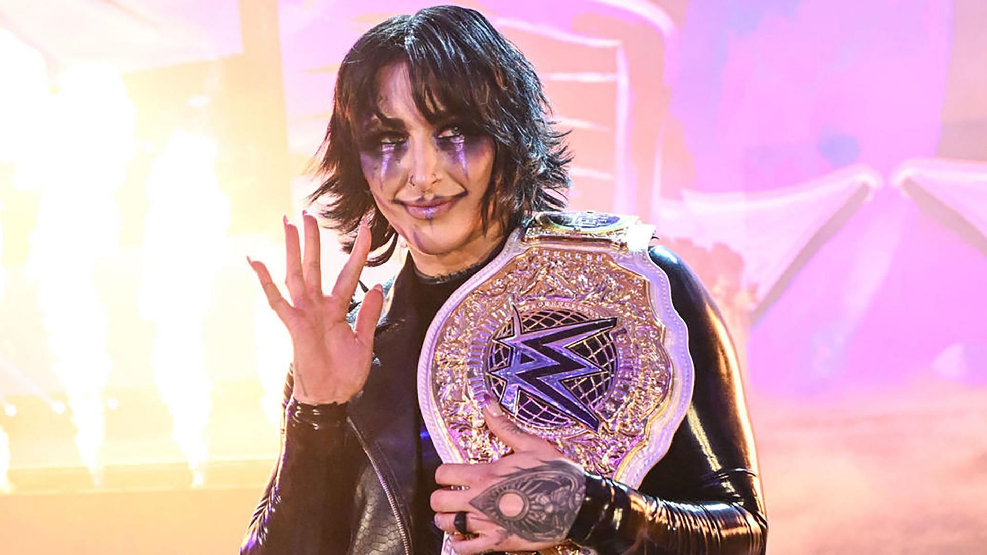 Rhea Ripley waves at her competition in the WWE ring