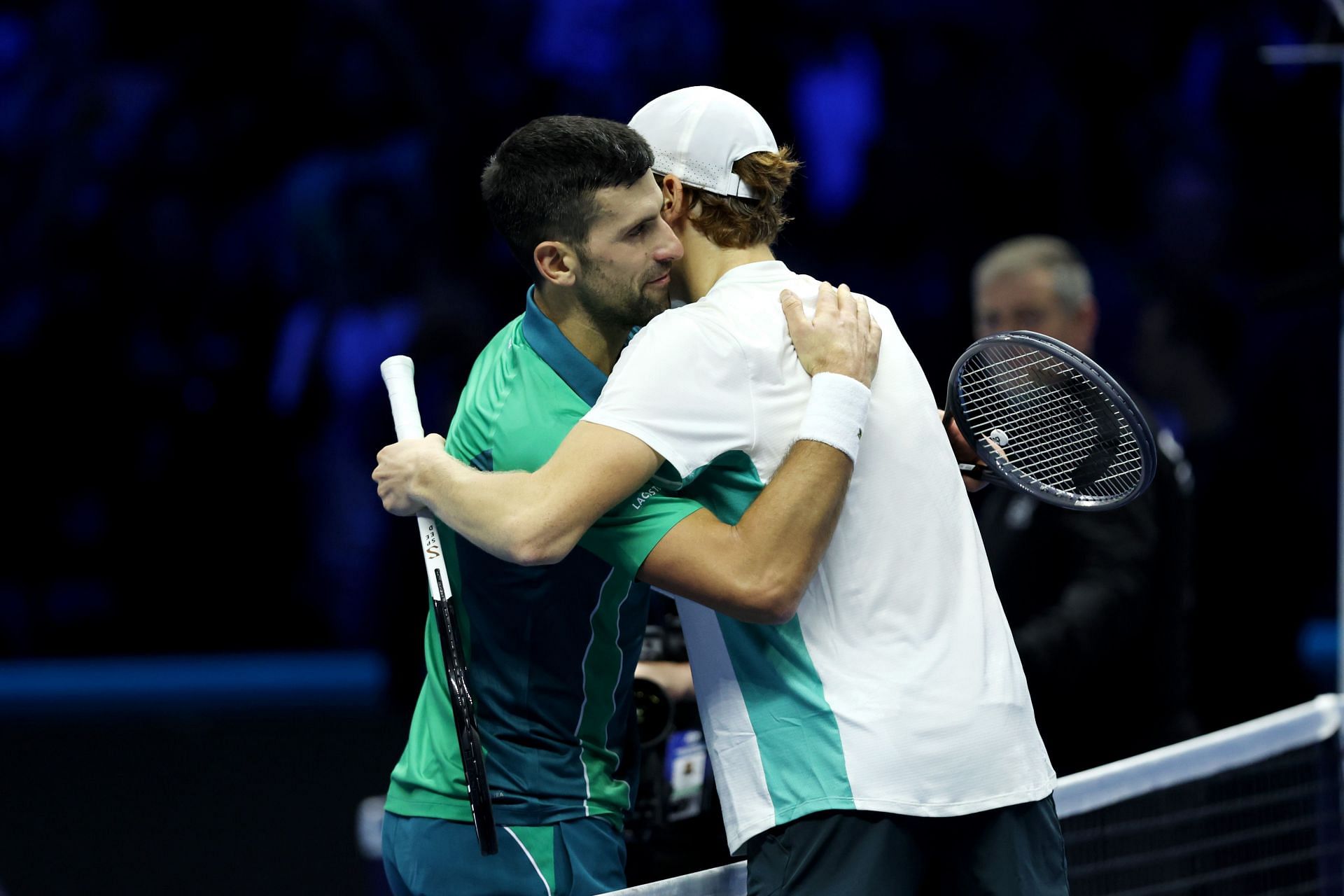 Novak Djokovic hugs Jannik Sinner at the net