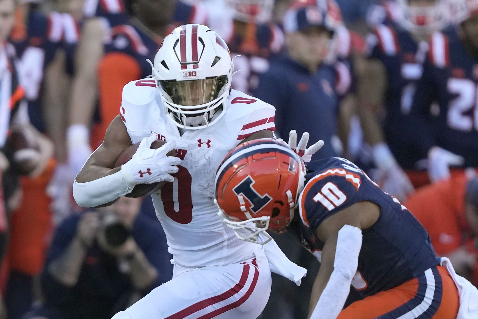 Wisconsin Badgers running back Braelon Allen carries the ball as Illinois defensive back Miles Scott makes a tackle (AP Photo/Charles Rex Arbogast)
