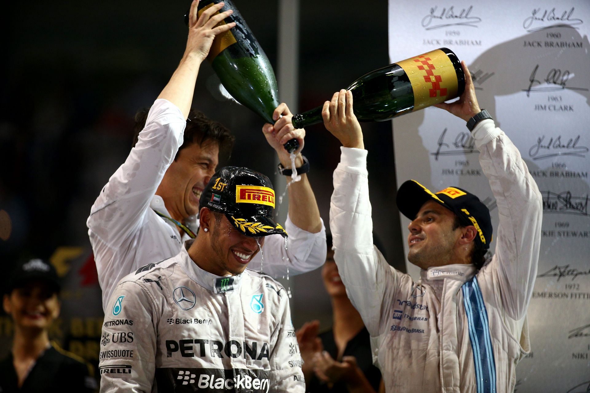 Lewis Hamilton celebrates his win with Mercedes team principal Toto Wolff and Williams&#039; Felipe Massa in the 2013 Abu Dhabi GP (Photo by Mark Thompson/Getty Images)