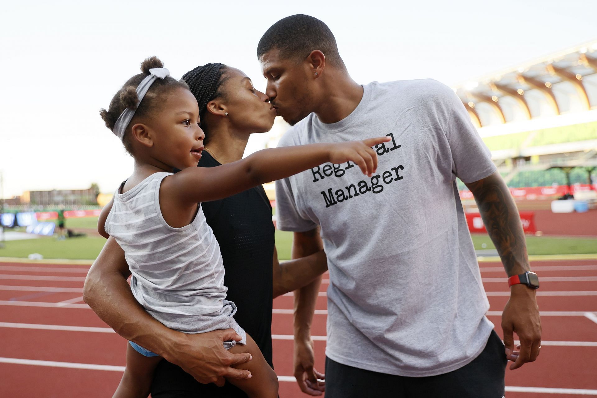 Allyson Felix kisses her husband Kenneth Ferguson while holding her daughter Camryn after the 2020 U.S. Olympic Track &amp; Field Team Trials at Hayward Field in Eugene, Oregon.