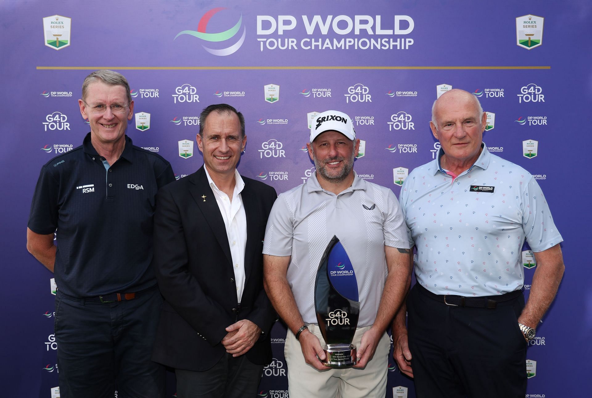 Mike Browne of England celebrates with the G4D trophy alongside Tony Bennett, President of Edga and Head of Disability and Inclusion for the IGF, Daniel Van Otterdijk, Group Chief Communications Officer of DP World and Eric Nicoli, Chairman of PGA European Tour Group, following the G4D Tour season finale (Image via Getty)