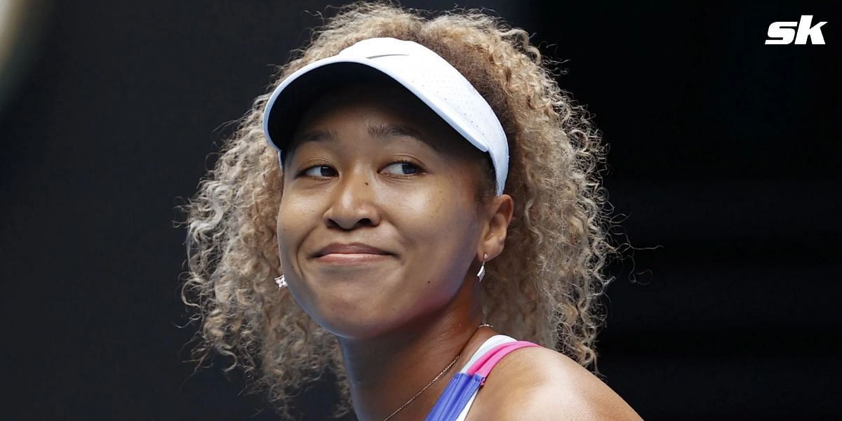 Naomi Osaka reacts to a fan donning her Nike shoes