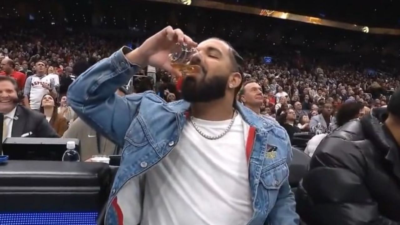 Drake polishing off his drink leading into the fourth quarter between the Boston Celtics and Toronto Raptors.