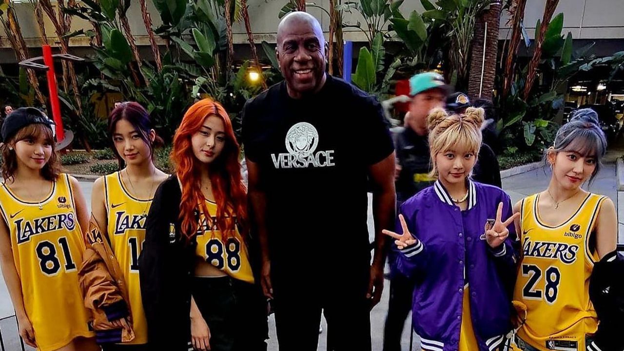 Magic Johnson poses for a picture with 