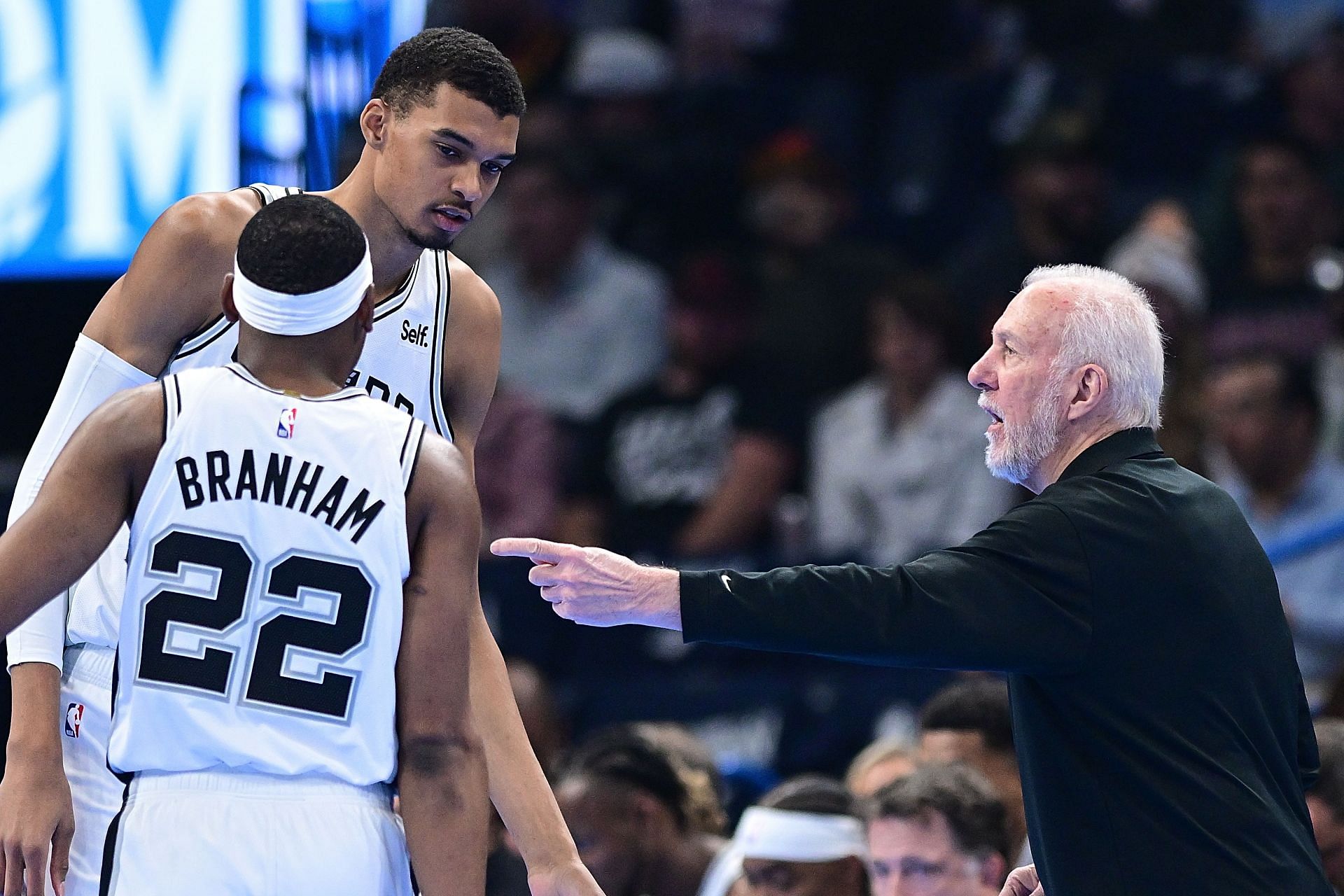 Coach Gregg Popovich of the San Antonio Spurs with Victor Wembanyama and Malaki Branham