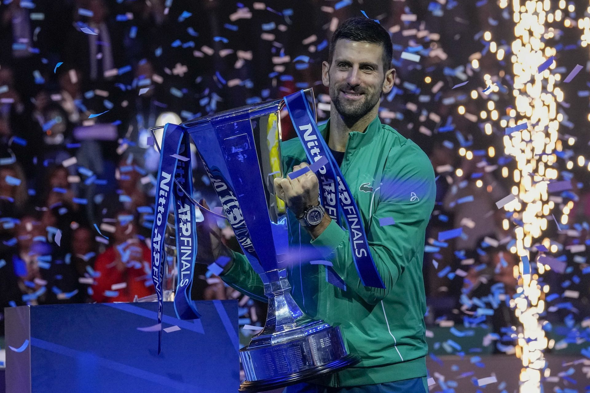 Novak Djokovic celebrates with the trophy at ATP Finals 2023