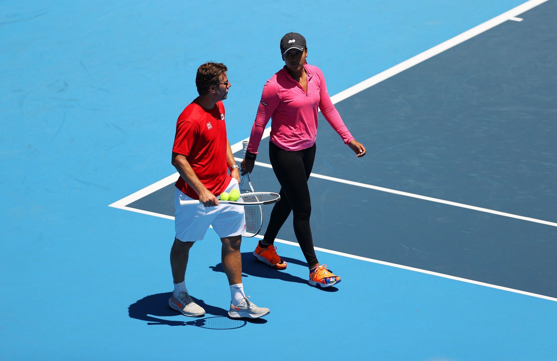 Naomi Osaka speaks with Wim Fissette during a practice session ahead of the 2020 Tokyo Olympics.