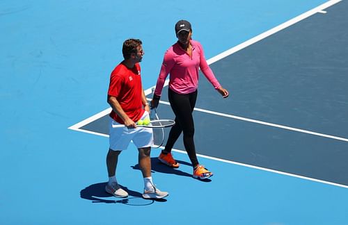 Naomi Osaka speaks with Wim Fissette during a practice session ahead of the 2020 Tokyo Olympics.