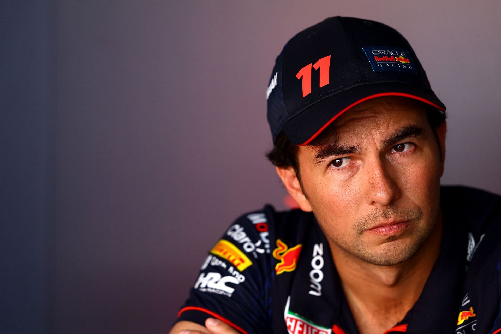 Sergio Perez of Mexico and Oracle Red Bull Racing looks on in the Paddock during previews ahead of the F1 Grand Prix of Abu Dhabi at Yas Marina Circuit on November 23, 2023 in Abu Dhabi, United Arab Emirates. (Photo by Mark Thompson/Getty Images)