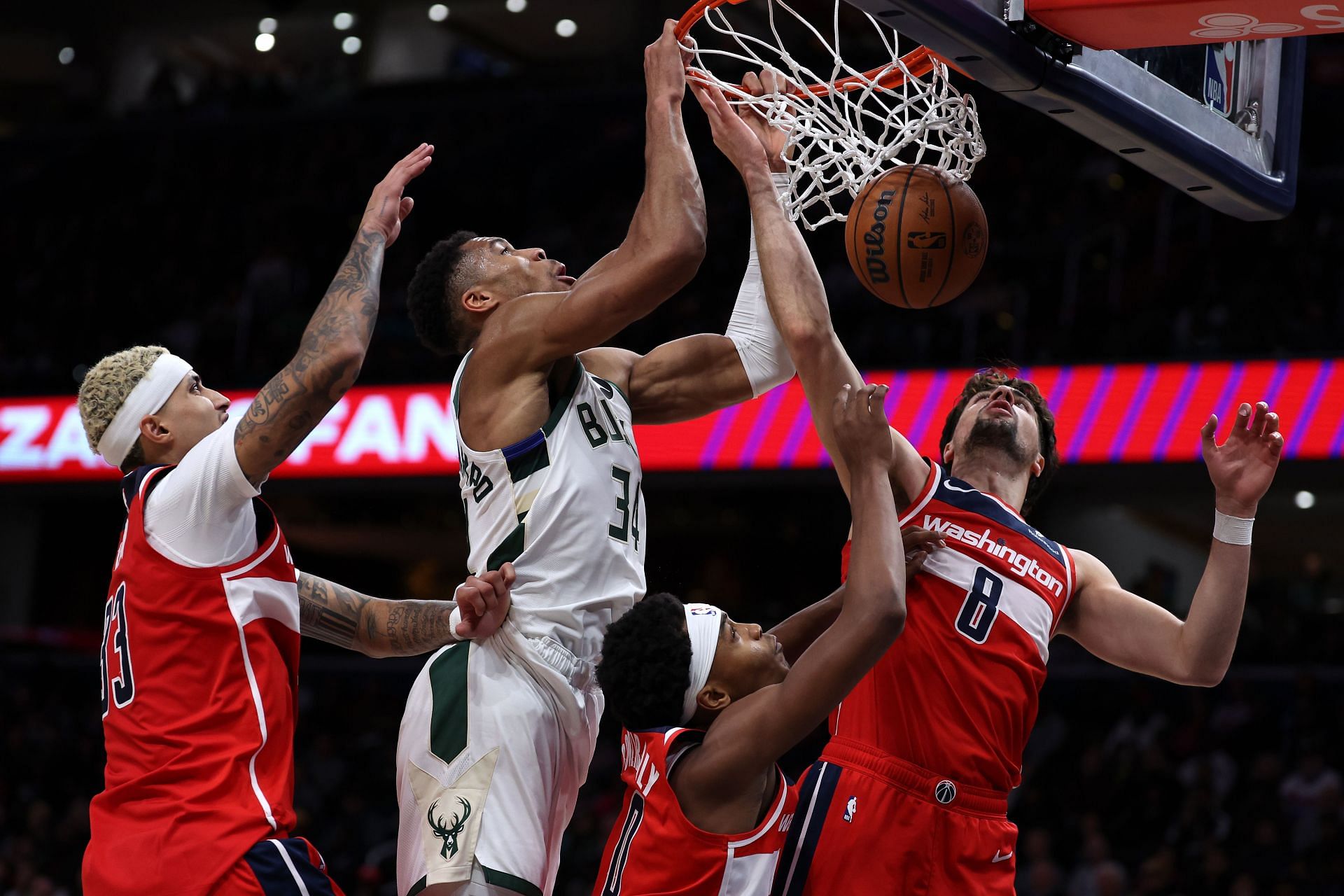 Giannis Antetokounmpo of the Milwaukee Bucks dunking all over the Washington Wizards