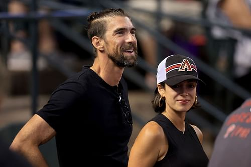 American swimmer Michael Phelps is seen with his wife Nicole Johnson before Game Four of the National League Championship Series between the Arizona Diamondbacks and the Philadelphia Phillies at Chase Field in Phoenix, Arizona.