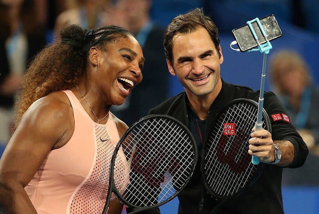 Roger Federer and Serena Williams pose for a selfie during a mixed doubles match at the 2019 Hopman Cup