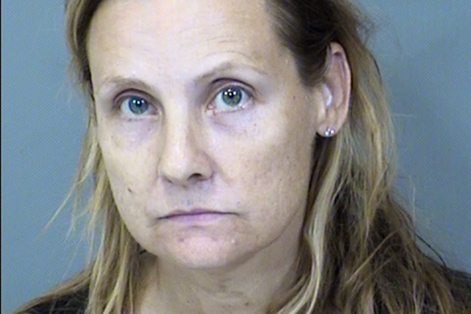 Social media users lashed out at the Arizona woman who allegedly hoarded dozens of dogs, tortured them, and was even found with the bodies of 5 puppies in the freezer. (Image via MARICOPA COUNTY SHERIFF