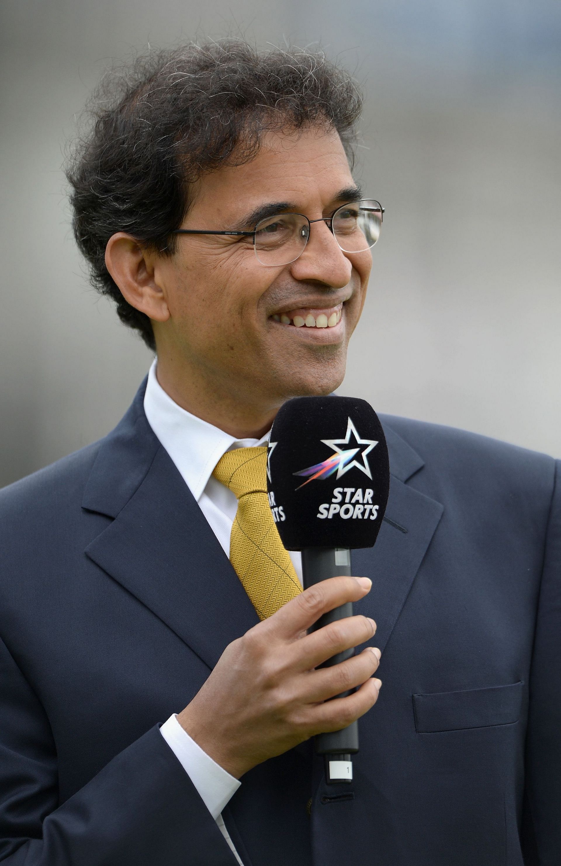 Harsha Bhogle on commentary duties.