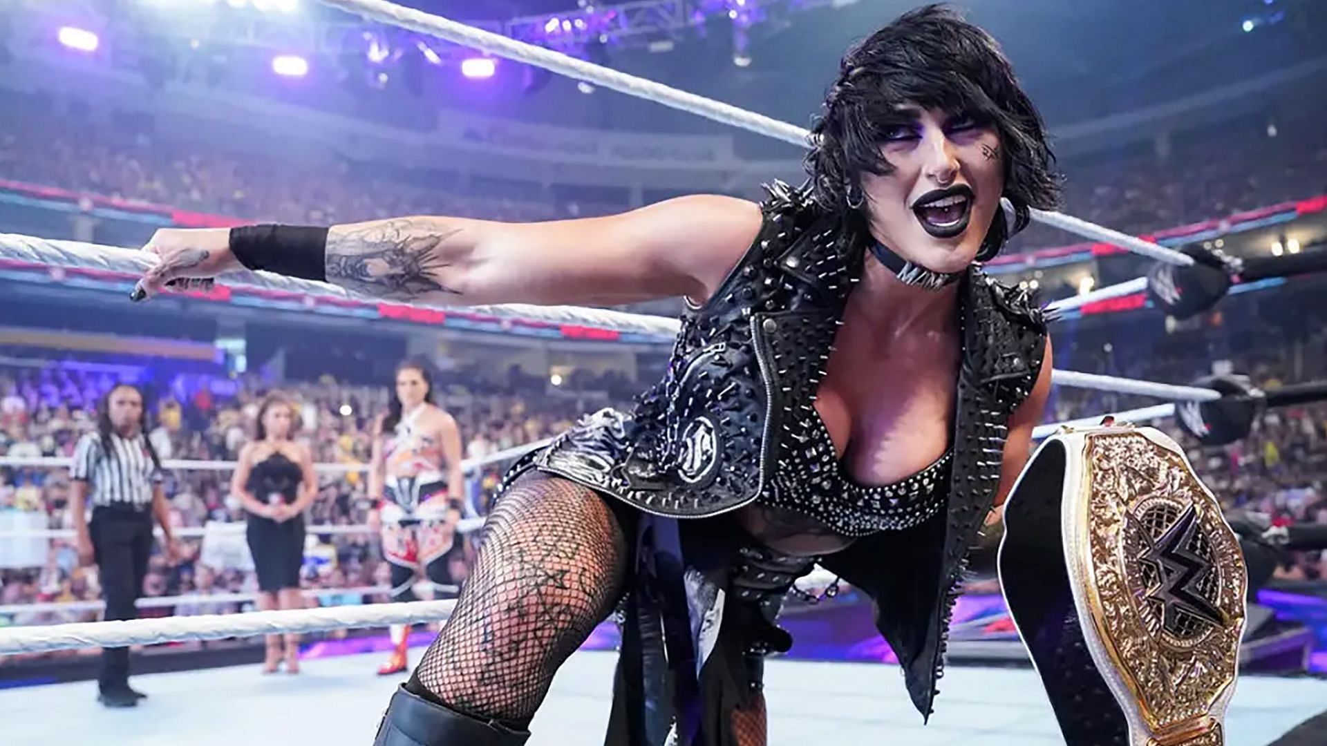 Rhea Ripley poses with the WWE World Women