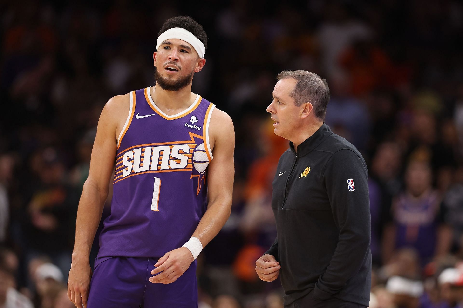 Head coach Frank Vogel of the Phoenix Suns talks with Devin Booker