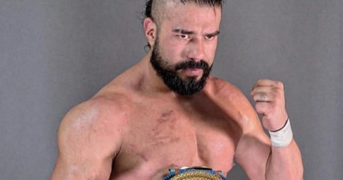 Andrade posing with his newly-won title.