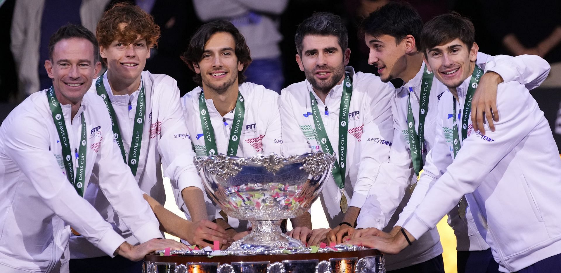 Jannik Sinner, Matteo Arnaldi, and the Italian team pictured after winning the 2023 Davis Cup title