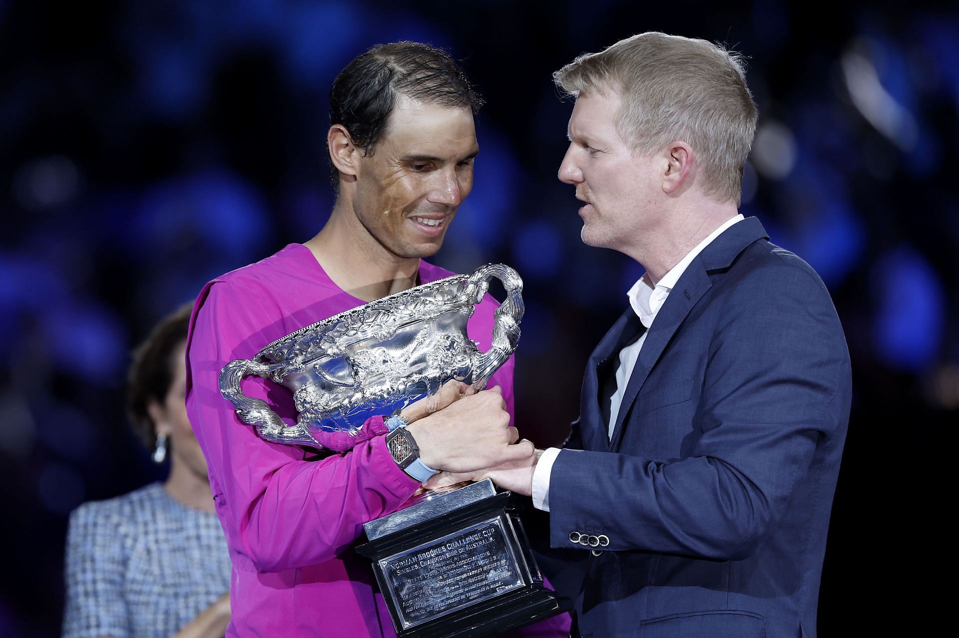 Rafael Nadal receives the 2022 Australian Open trophy from Jim Courier.