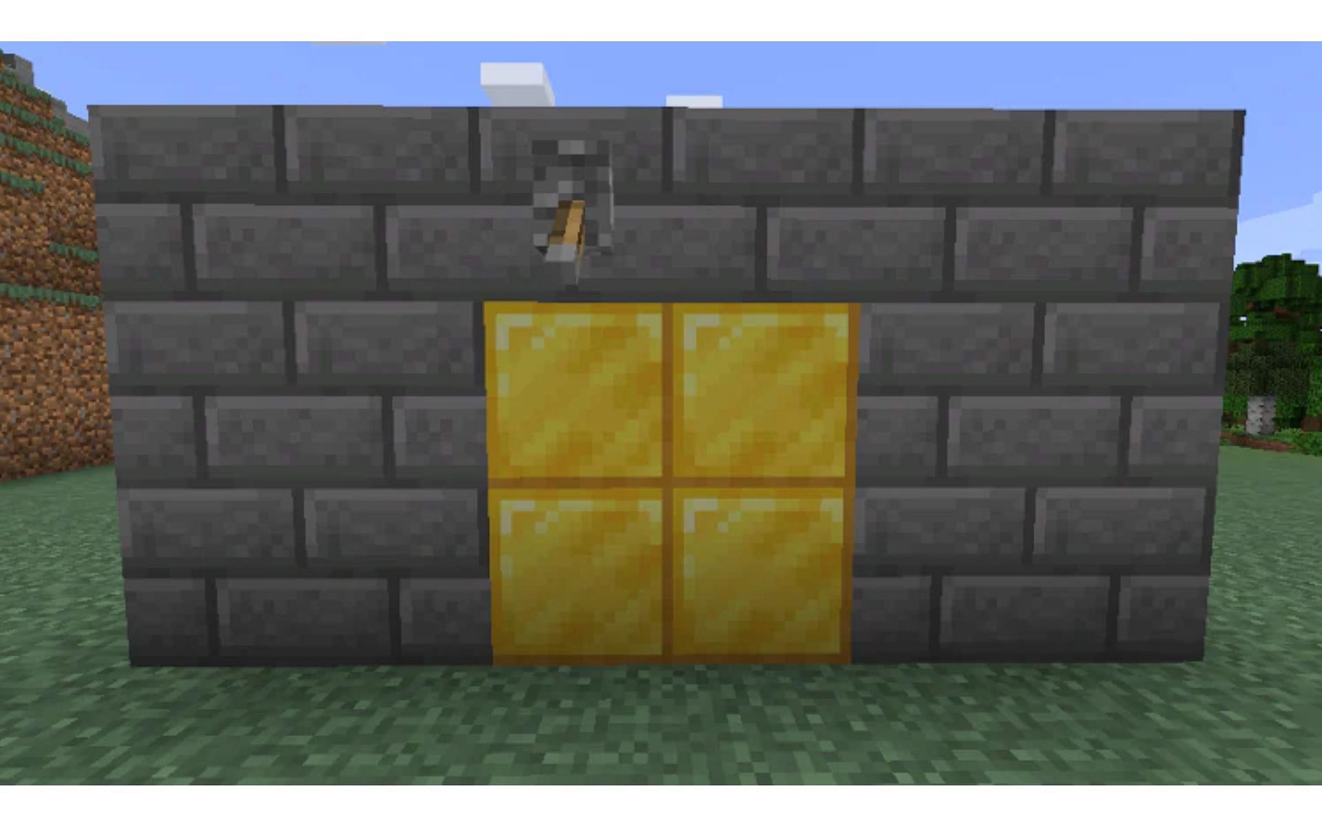 Players can make a hidden door by using redstone engineering (Image via Mojang)