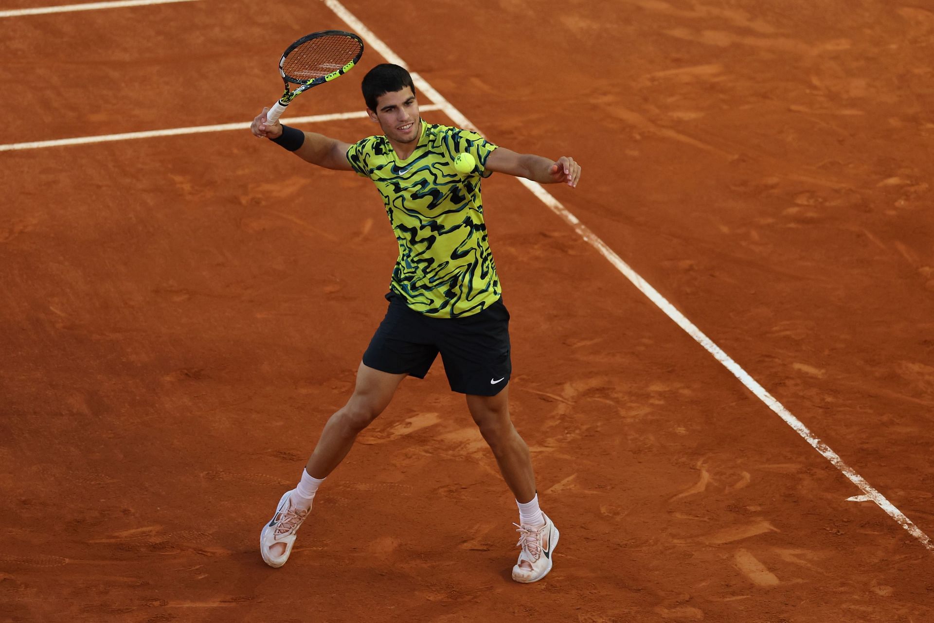 Carlos Alcaraz celebrates match point at Mutua Madrid Open 2023