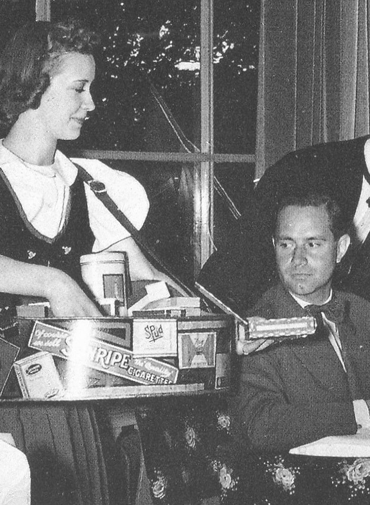 A cigarette girl in the 1940s (Image via Wikimedia Commons)