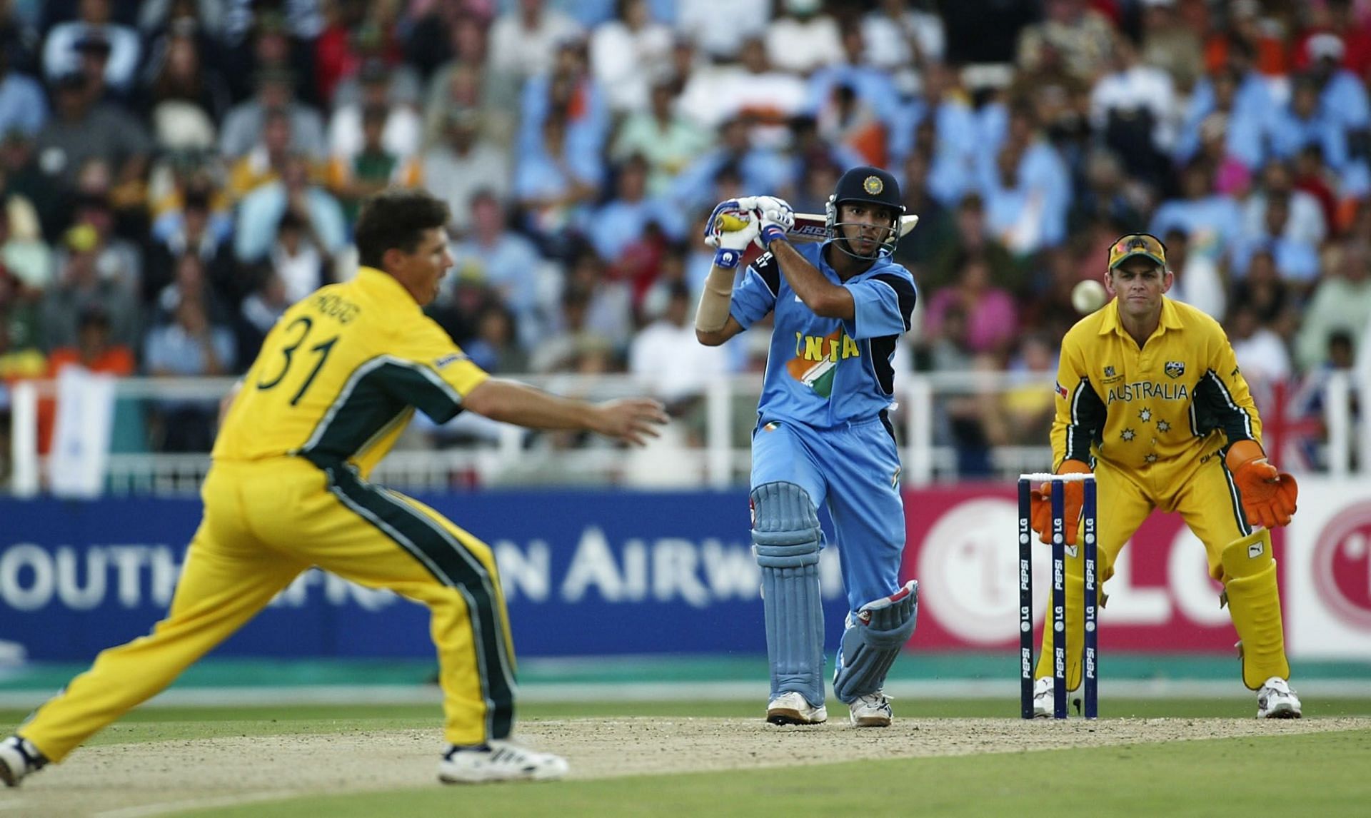 Yuvraj Singh of India hits out at the bowling of Brad Hogg of