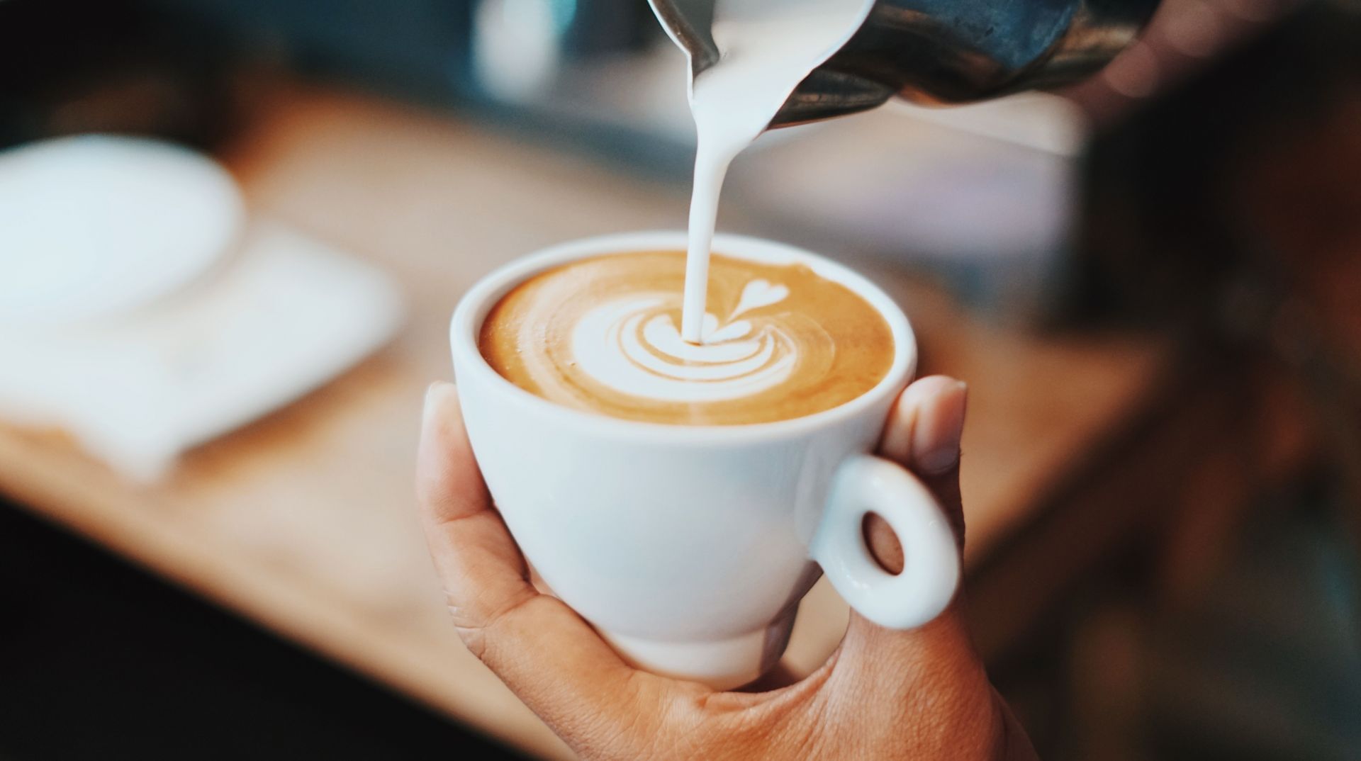 Honey in coffee (Image via Unsplash/Fahmi)